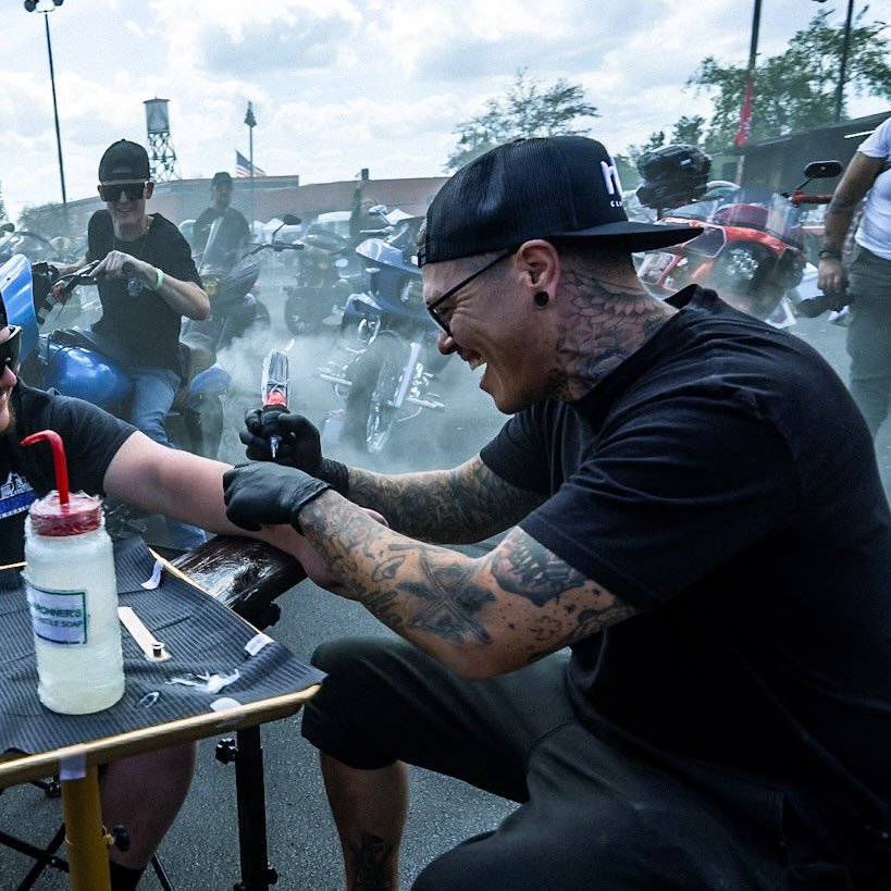 Jay Ortega tattooing at an outdoor event